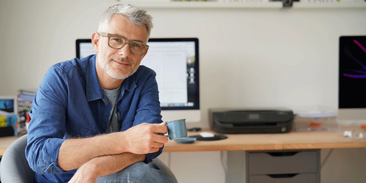 A user interface designer drinking coffee